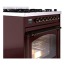 Burgundy dual fuel range with bronze control knobs and open oven door