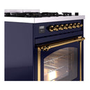 Midnight blue dual fuel range with brass control knobs and stainless oven vent.