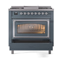 Blue grey dual-fuel gas range front view with lit oven window and top control row