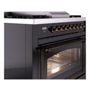 Glossy black dual-fuel range with bronze control knobs and lit oven window