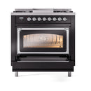 Glossy black dual fuel range front view with oven door open and glowing interior
