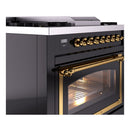 Glossy black range with brass bar handle and oven door window, front corner close-up