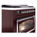 Burgundy dual fuel range with side panel, chrome knobs row, and oven window