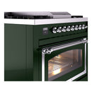 Emerald green range side view with burner knobs and chrome handle over lit oven door