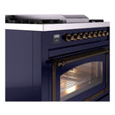 Midnight blue dual-fuel gas range with bronze knobs and lit oven window