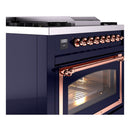 Midnight blue gas range corner view with copper control knobs and copper-framed glass oven door