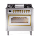 Stainless steel dual fuel range with brass knobs, cooktop burners, and oven glass window