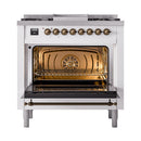 White dual fuel gas range, oven door open showing interior racks through glass