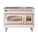 Antique white freestanding dual fuel range with copper trim and two oven doors with windows.