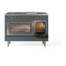 Freestanding dual fuel range with blue grey doors, brass trim, both ovens lit behind glass
