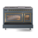 Freestanding dual fuel range front, blue grey body with brass handles and lit oven interiors