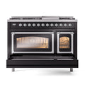 Glossy black dual fuel range with both ovens closed, warm oven window glow visible