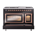 Freestanding dual-fuel gas range, black with copper trim, ovens open and lower drawer extended