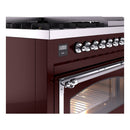 Burgundy range control panel and chrome oven handle above lit oven cavity