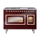 Burgundy dual fuel range with copper-trimmed doors, lit oven windows, and control knobs