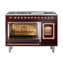 Burgundy dual fuel range with copper trim, left oven open and right oven window lit