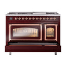 Burgundy dual fuel range with copper trim, one oven open and both oven cavities lit