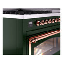Close-up of emerald green dual fuel range with copper control knobs and oven handle.