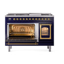 Midnight blue freestanding range with left oven open and right oven window; brass trim.