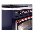 Midnight blue gas dual fuel range with copper control knob rail and open oven door