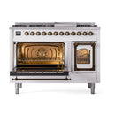 Freestanding range with oven door open, bronze handles, and interior racks