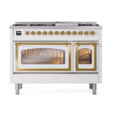 Freestanding dual fuel range with brass-trimmed ovens and gold control knobs