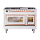 Freestanding dual fuel range with copper-trimmed doors and lit oven windows