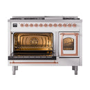 Freestanding dual fuel gas range with one oven open and the second door open, copper trim