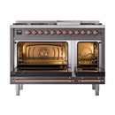 Freestanding dual fuel range with both oven doors open, showing oven racks and copper accents.