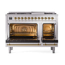 Stainless steel dual fuel range with brass-trimmed, double solid-door ovens open and gas burners visible