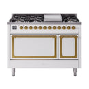 White freestanding dual fuel range with brass-trimmed oven doors and control panel