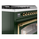 Emerald green range close-up of brass knobs and open oven door window