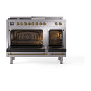 Stainless steel dual fuel range with brass-trim knobs and open oven doors