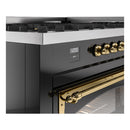 Close-up of glossy black range controls and brass oven handle with open door