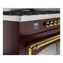 Burgundy range control panel with brass knobs, display, and oven door handle