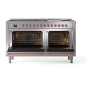Stainless steel dual-fuel range with both oven doors open, interior racks, copper trim