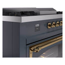 Blue grey dual fuel range control panel with brass knobs and digital display clock.