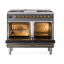 ILVE dual fuel range with two oven cavities open, brass interior frames, and glass doors