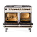 Antique white dual-fuel gas range with open solid-door ovens and bronze control knobs