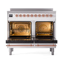 Induction range with two open oven doors, copper trim, and illuminated oven interiors