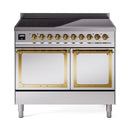 Freestanding induction range with black cooktop, gold knobs, and two front oven doors