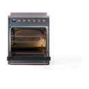Open triple-glass oven door on blue grey induction range with brass accents