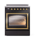 Black induction range with brass control knobs and oven door window