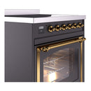 Side view of matte graphite induction range with gold control knobs and brass oven handle