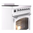 White induction range with chrome control knobs and open oven door, interior light