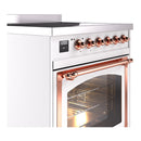 White induction range with copper control knobs and large glass oven door