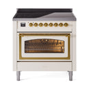 Antique white induction range with brass control knobs and open glass oven door