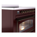 Burgundy induction range oven control knobs with bronze trim and open oven door