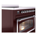 Burgundy induction range control panel with chrome knobs and glass oven door