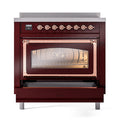Burgundy oven with open triple glass door, copper handle frame, and control knobs above